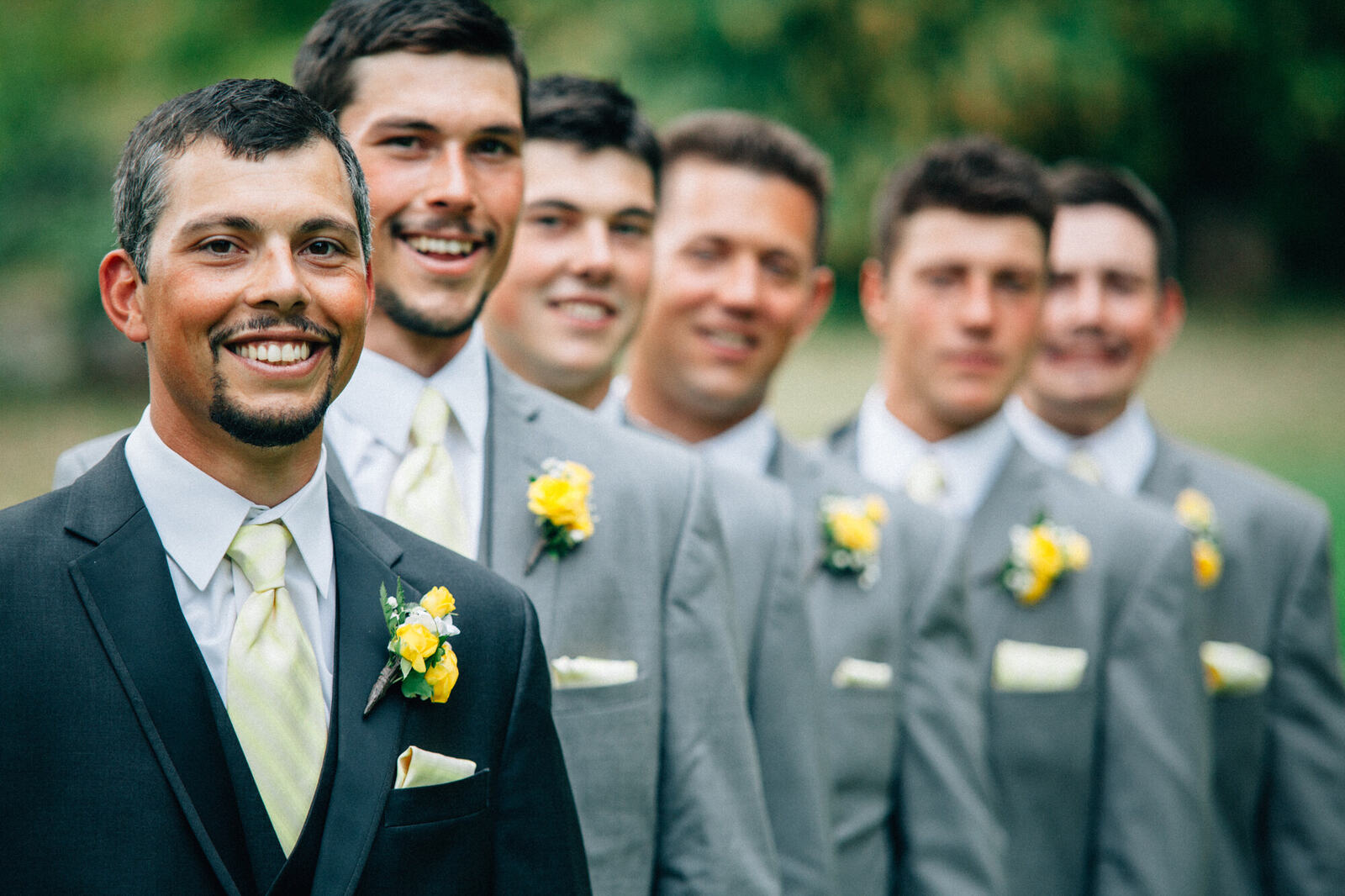 Groomsmen smiling together outdoors