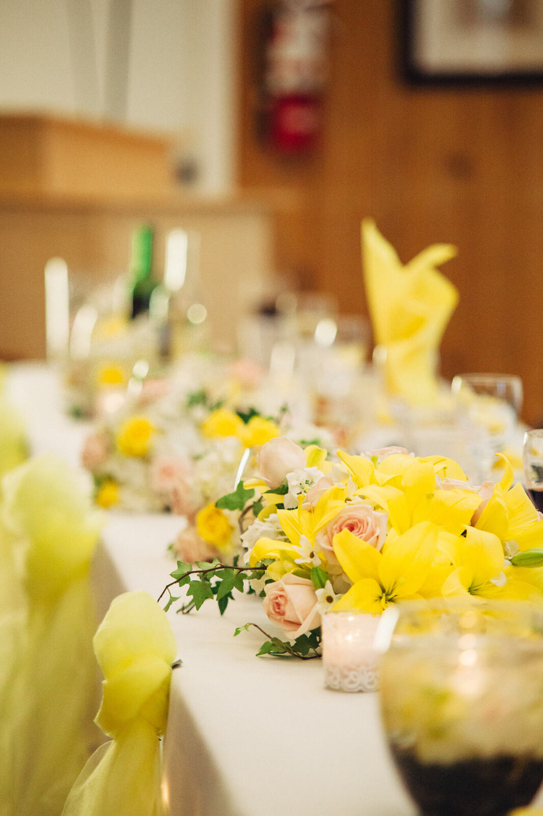 Yellow flowers and candlelight on the reception tables