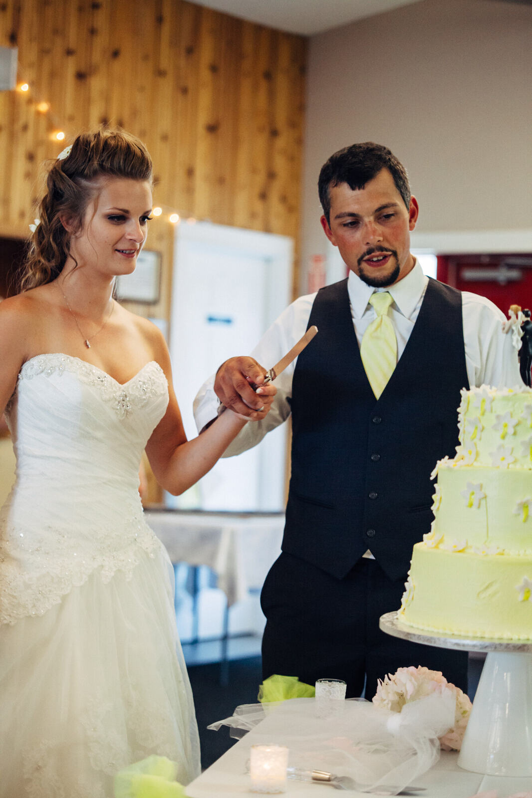 Mel and Blaise cutting their wedding cake