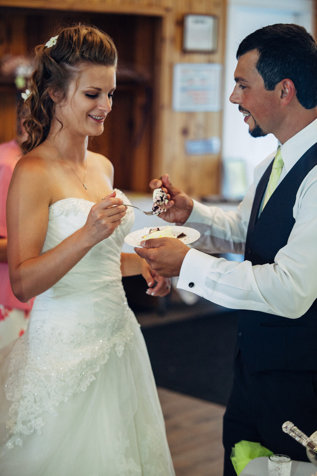 Mel and Blaise sharing cake at the reception