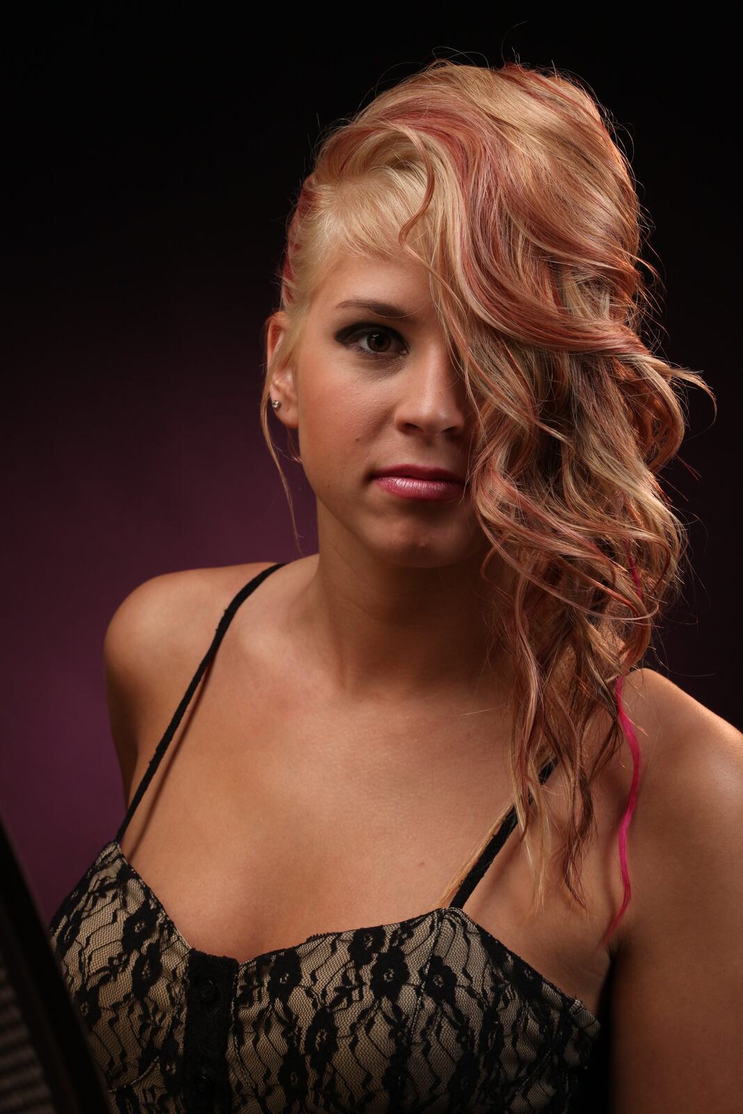 Bright studio headshot of Michaela with curled hair