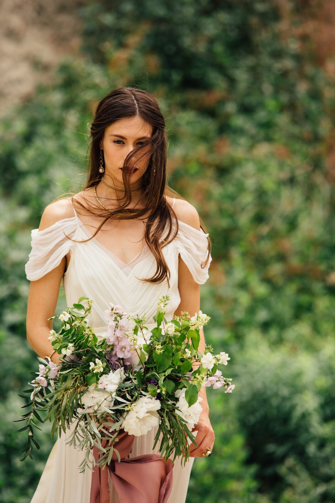 Nicole, White Willow portraits story frame 12: Nicole in a White Willow Photography-designed bridal editorial near Salmon Arm, moving from rock-face portraits through bouquet, veil and flower-crown details.