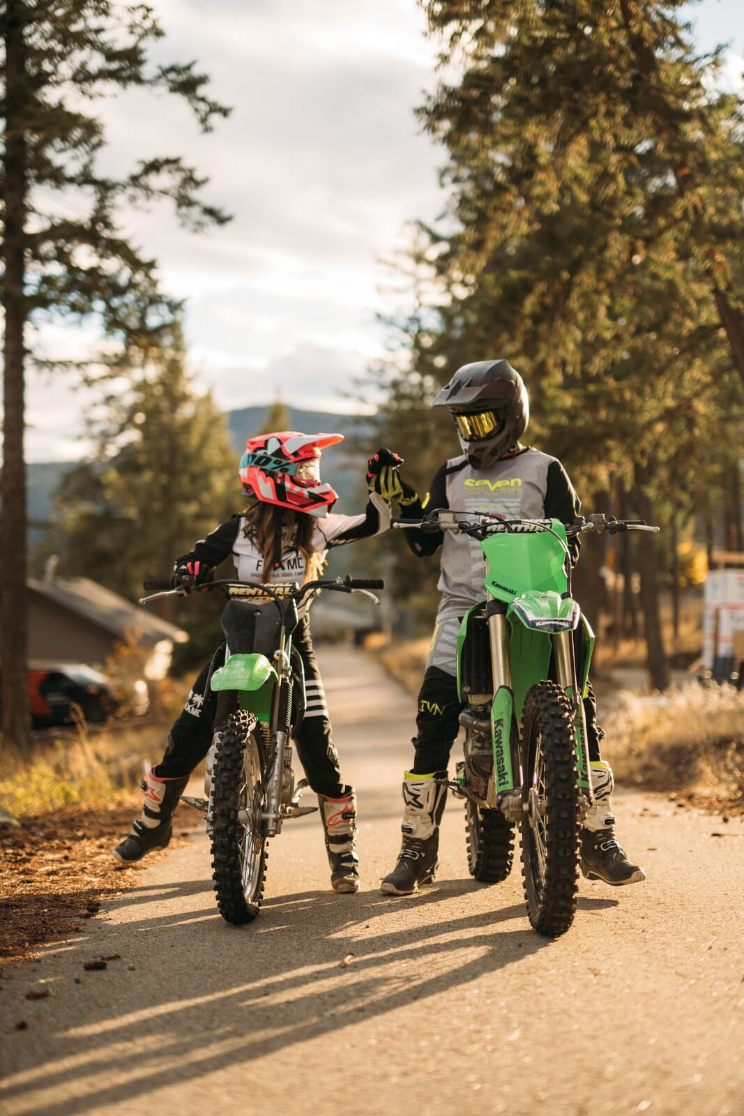 Rachel and Ryan portraits story frame 2: Okanagan couples portraits with dirt bikes, lake and mountain views, autumn sun, standing portraits and champagne celebration.