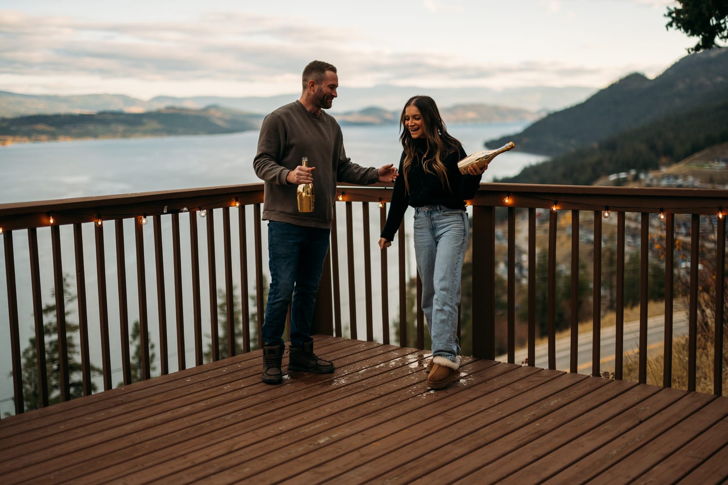 Rachel and Ryan portraits story frame 12: Okanagan couples portraits with dirt bikes, lake and mountain views, autumn sun, standing portraits and champagne celebration.