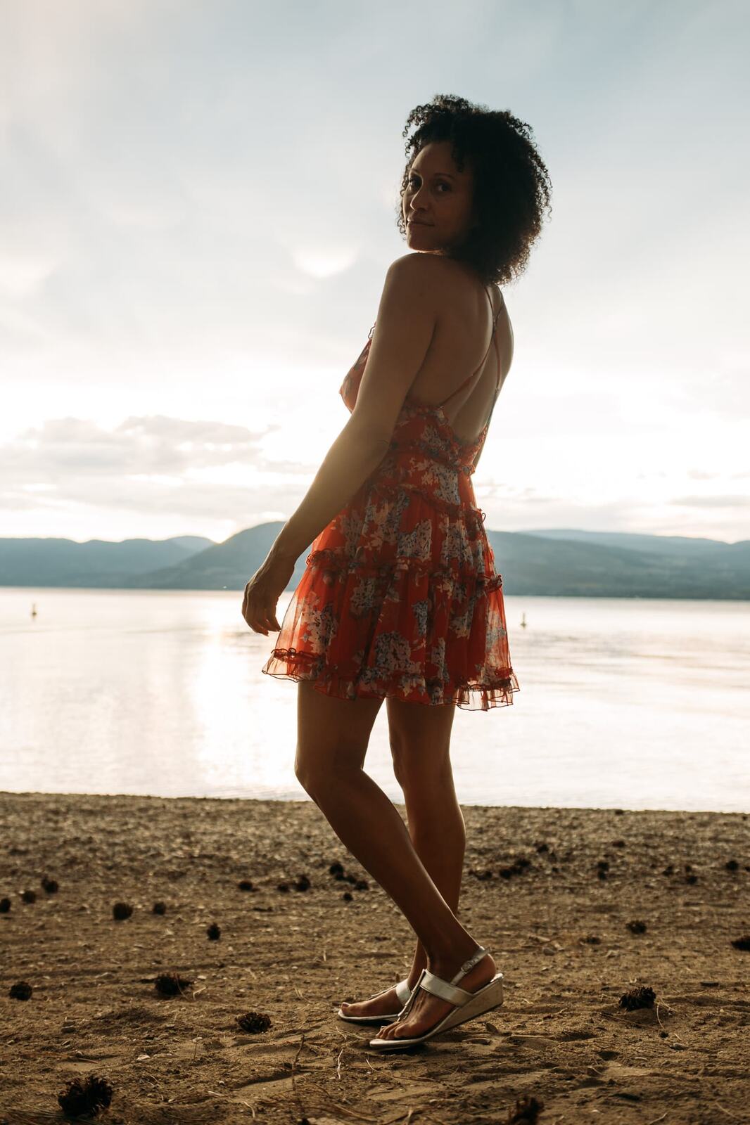 Rebekah at Bertram portraits story frame 10: A Bertram portrait story moving from floral dress and lake light into black dress, white shirt, sunset and water silhouettes.