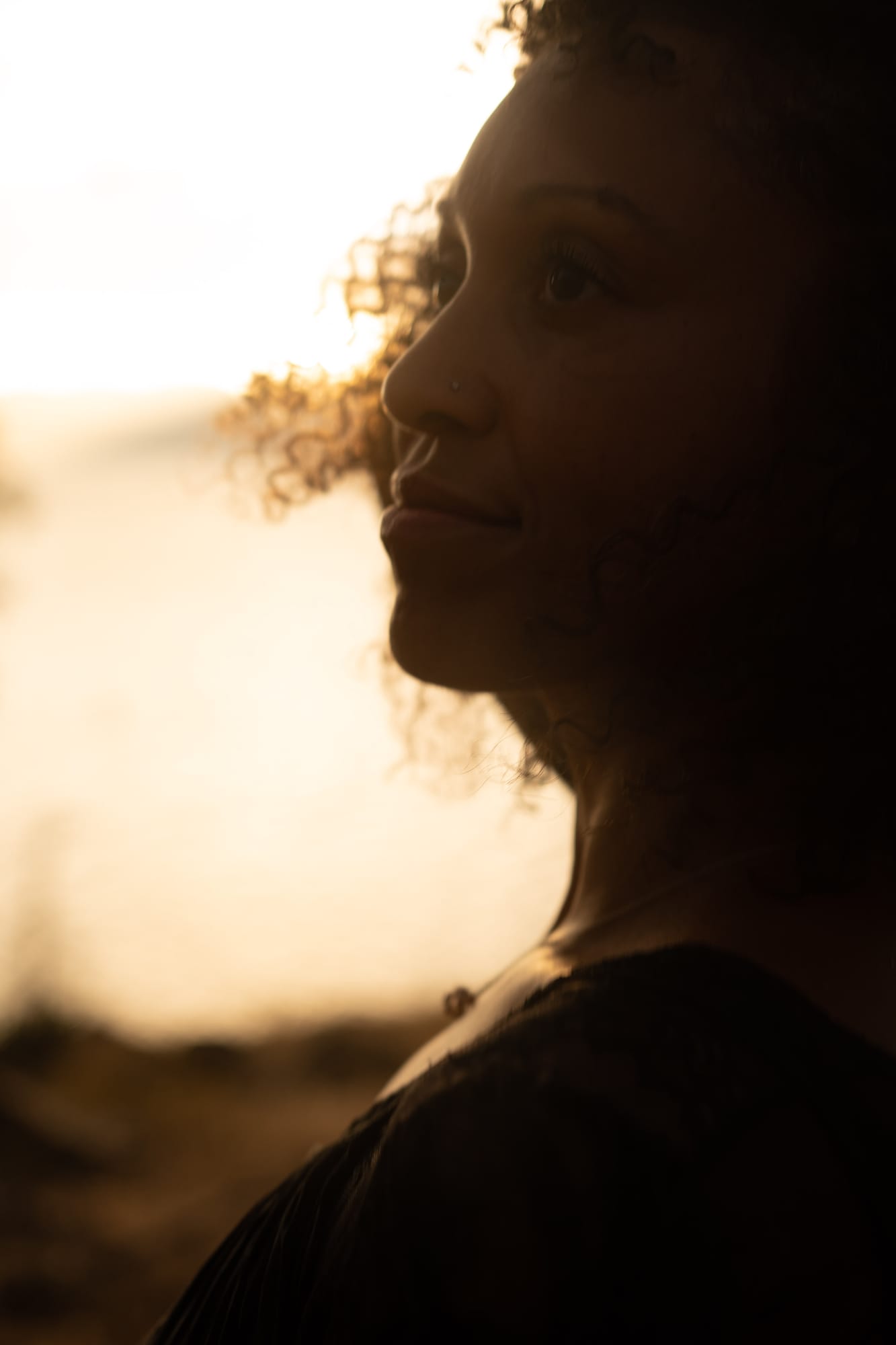 Rebekah at Bertram portraits story frame 13: A Bertram portrait story moving from floral dress and lake light into black dress, white shirt, sunset and water silhouettes.