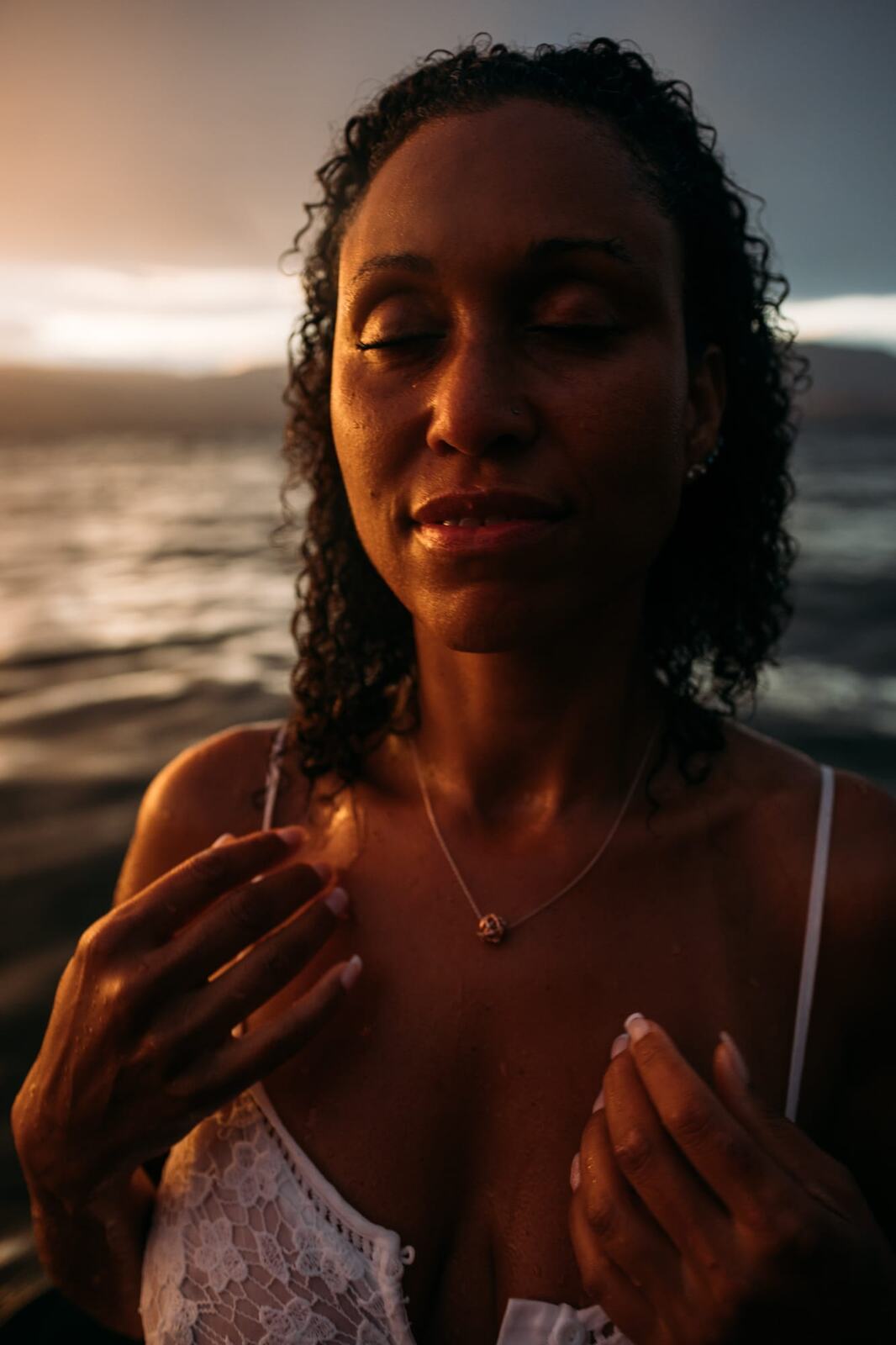 Rebekah at Bertram portraits story frame 17: A Bertram portrait story moving from floral dress and lake light into black dress, white shirt, sunset and water silhouettes.