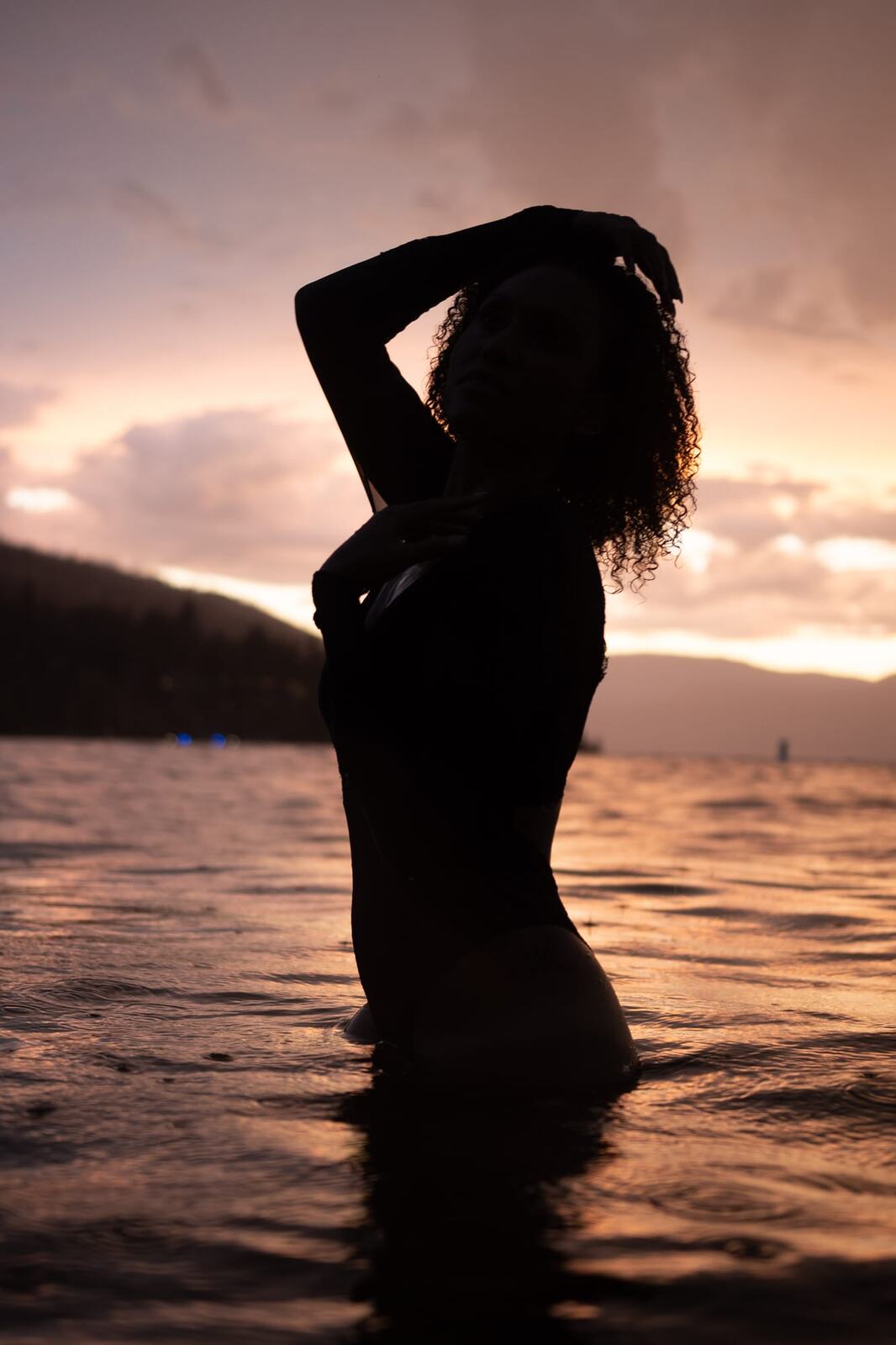 Rebekah at Bertram portraits story frame 19: A Bertram portrait story moving from floral dress and lake light into black dress, white shirt, sunset and water silhouettes.