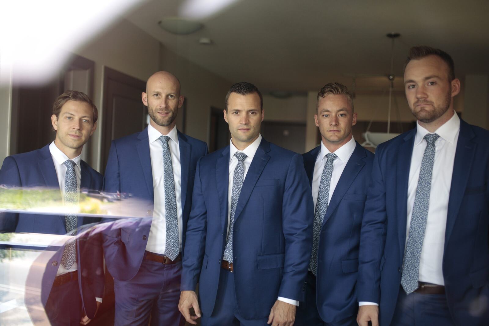 Greg and his groomsmen sharing a relaxed moment before the ceremony