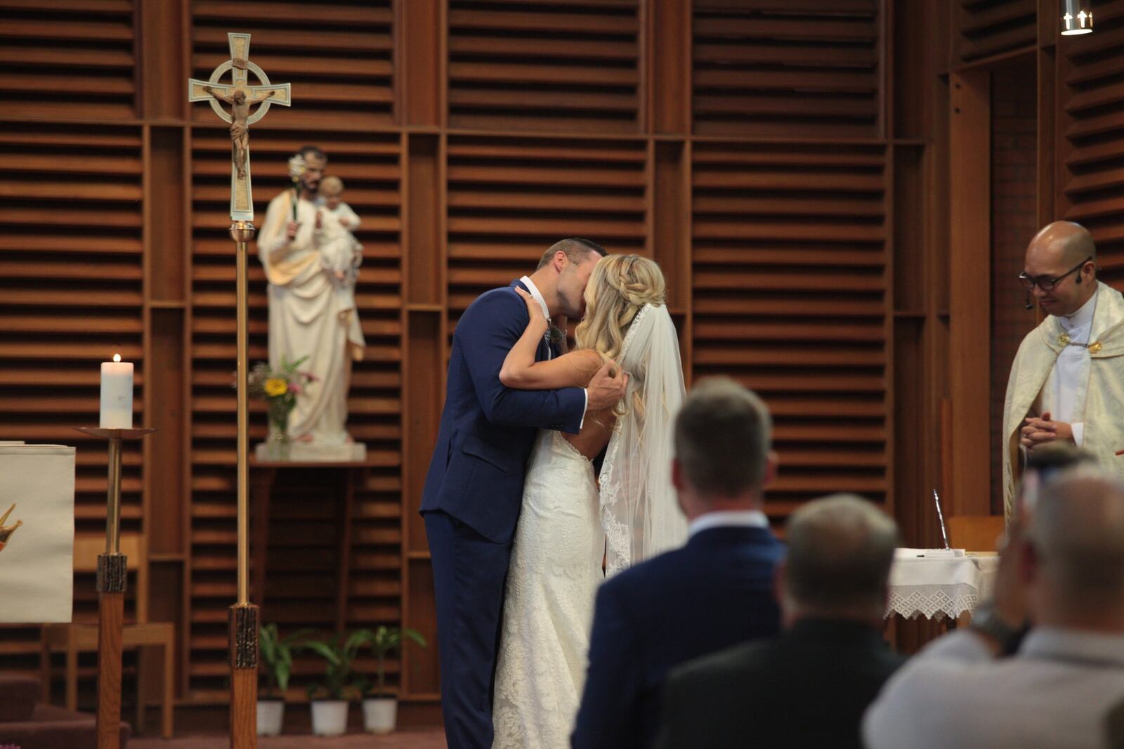 Sarah and Greg sharing their first kiss during the ceremony