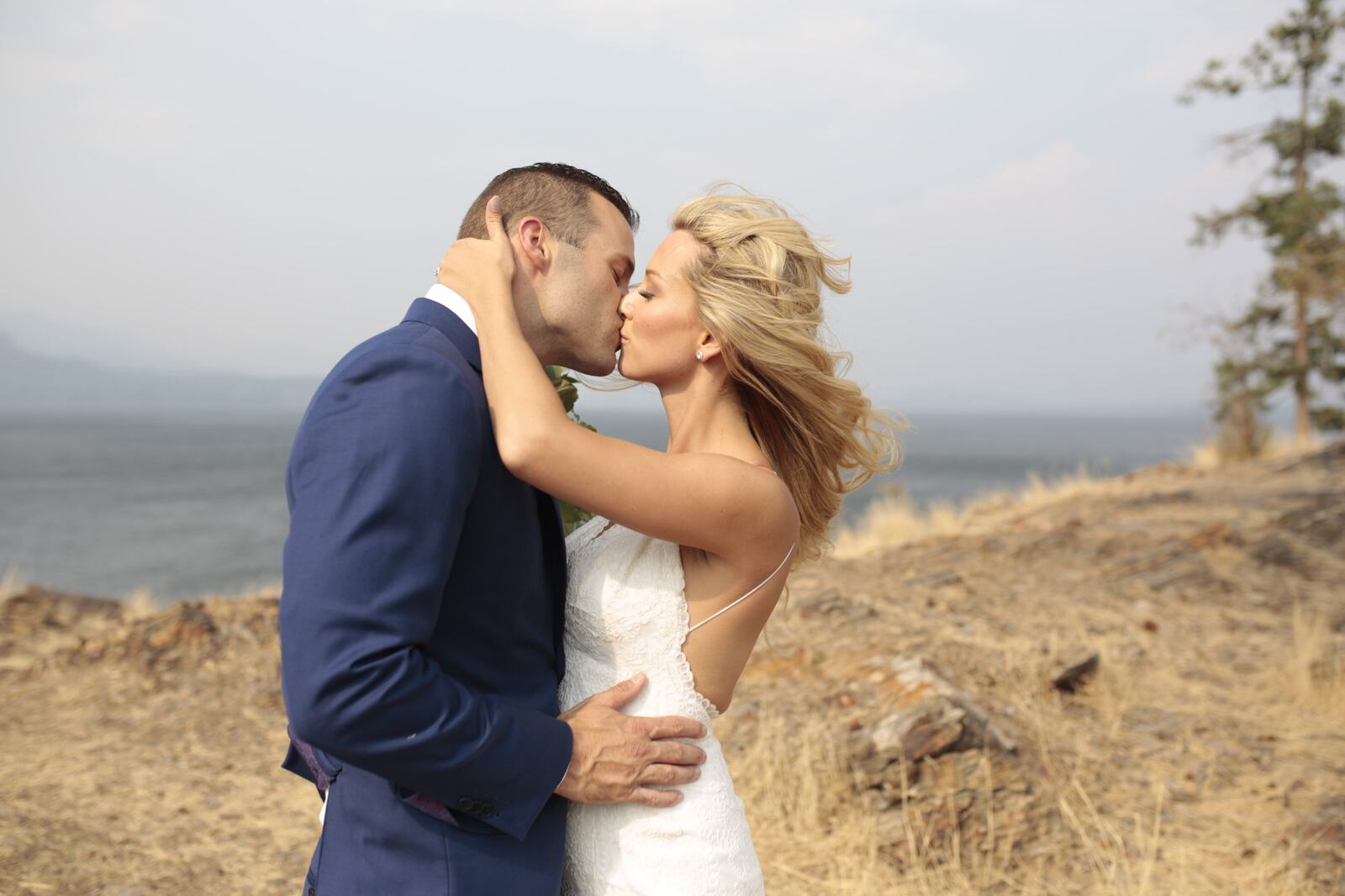 Sarah and Greg kissing above the lake