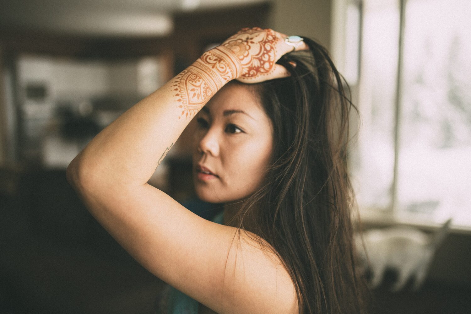 Sarah: Henna, Snow and Candlelight portraits story frame 2: A four-part portrait story with Sarah in Kelowna, moving from a living-room henna session into snow, a daylight coconut-milk bath and a candlelit bath.