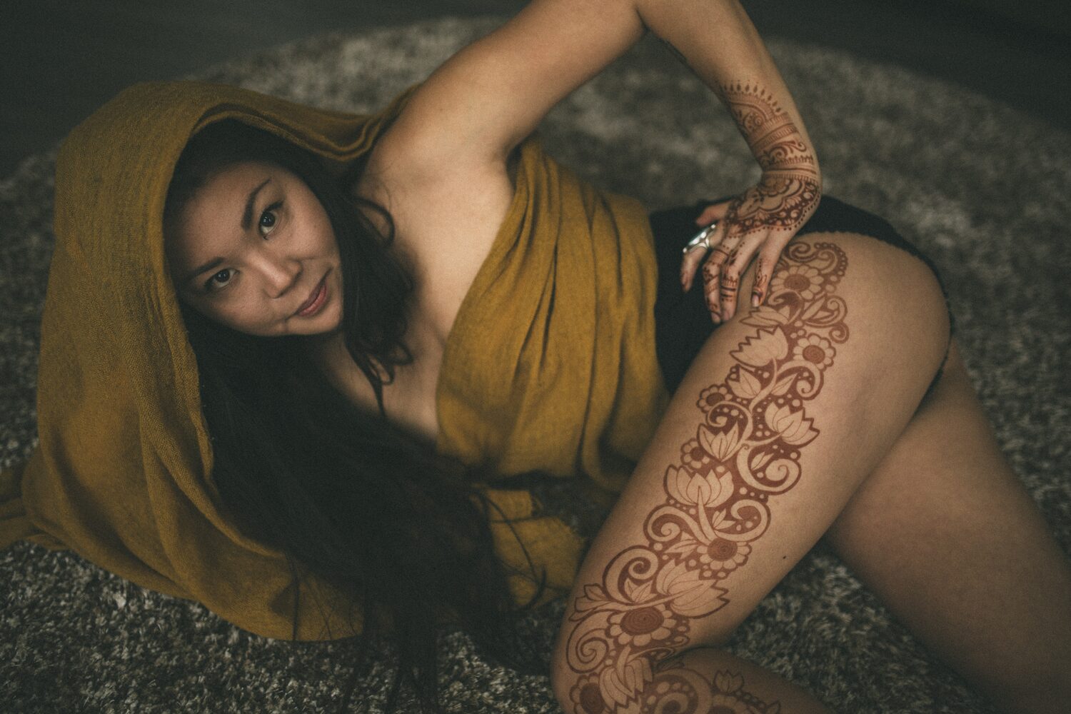 Sarah: Henna, Snow and Candlelight portraits story frame 6: A four-part portrait story with Sarah in Kelowna, moving from a living-room henna session into snow, a daylight coconut-milk bath and a candlelit bath.