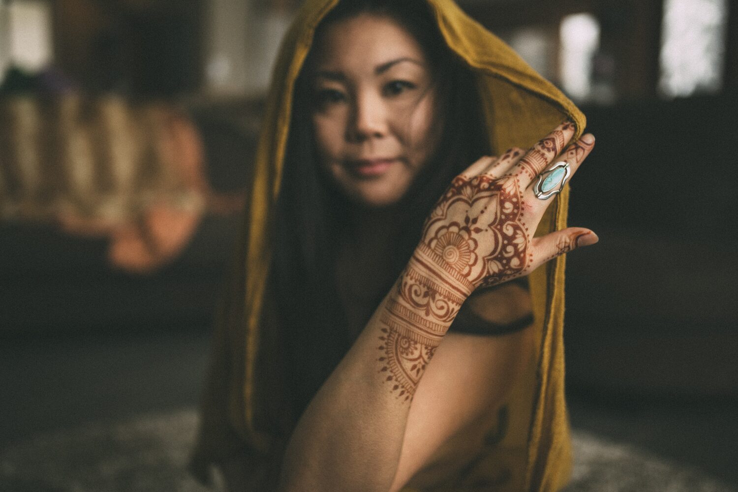 Sarah: Henna, Snow and Candlelight portraits story frame 7: A four-part portrait story with Sarah in Kelowna, moving from a living-room henna session into snow, a daylight coconut-milk bath and a candlelit bath.