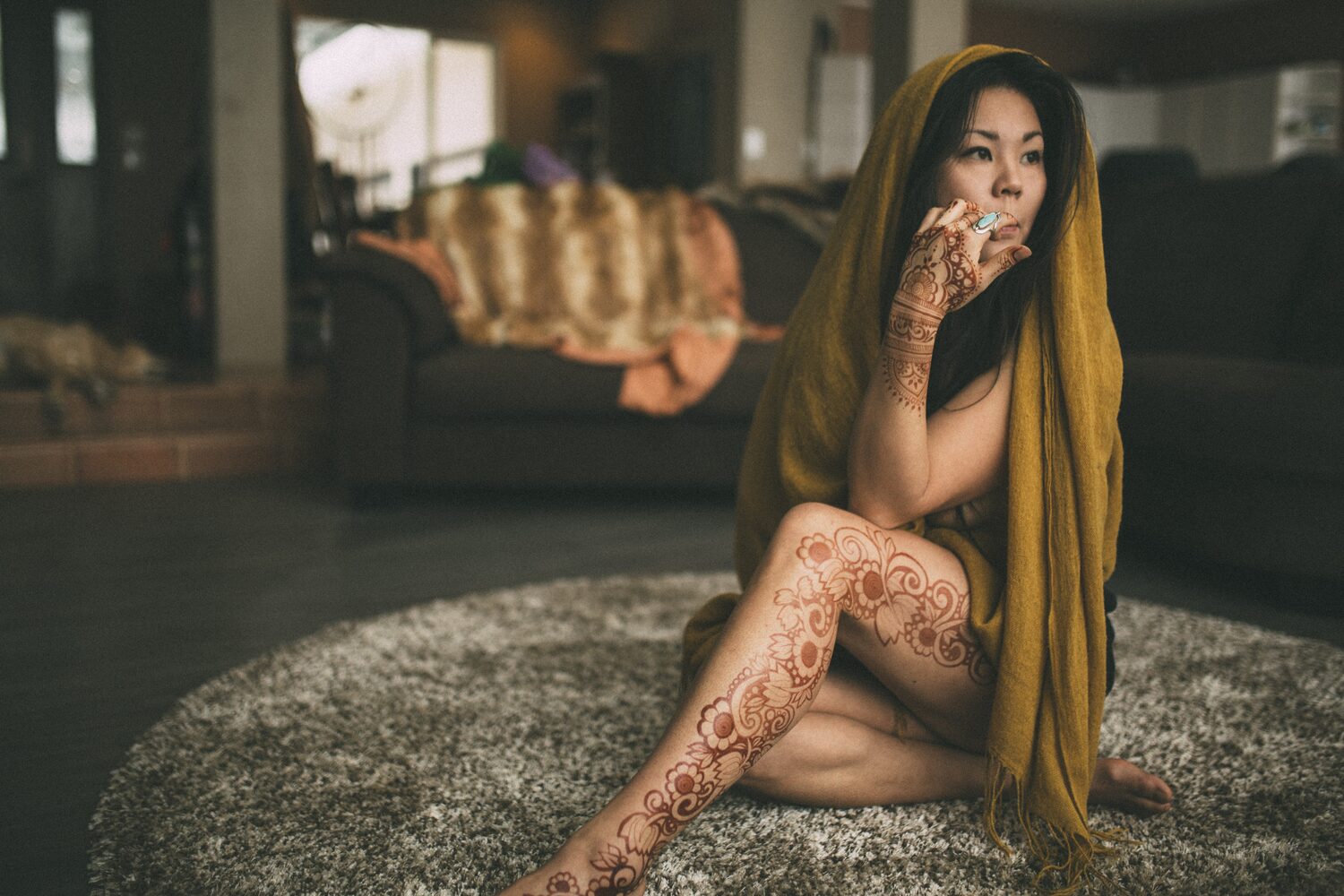 Sarah: Henna, Snow and Candlelight portraits story frame 8: A four-part portrait story with Sarah in Kelowna, moving from a living-room henna session into snow, a daylight coconut-milk bath and a candlelit bath.