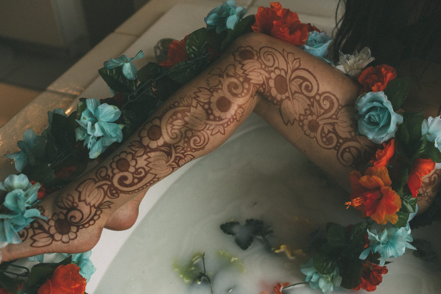 Sarah: Henna, Snow and Candlelight portraits story frame 19: A four-part portrait story with Sarah in Kelowna, moving from a living-room henna session into snow, a daylight coconut-milk bath and a candlelit bath.