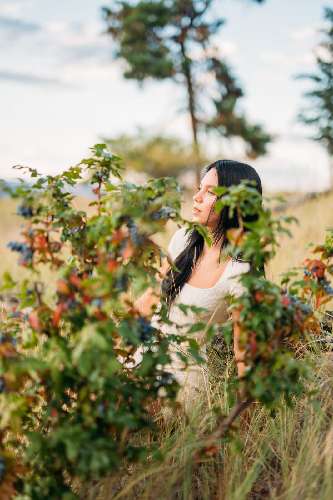 Shaylin at Bertram portraits story frame 6: A large Bertram session with water, green shade, outfit changes and Okanagan location detail that gives the story a clear place.