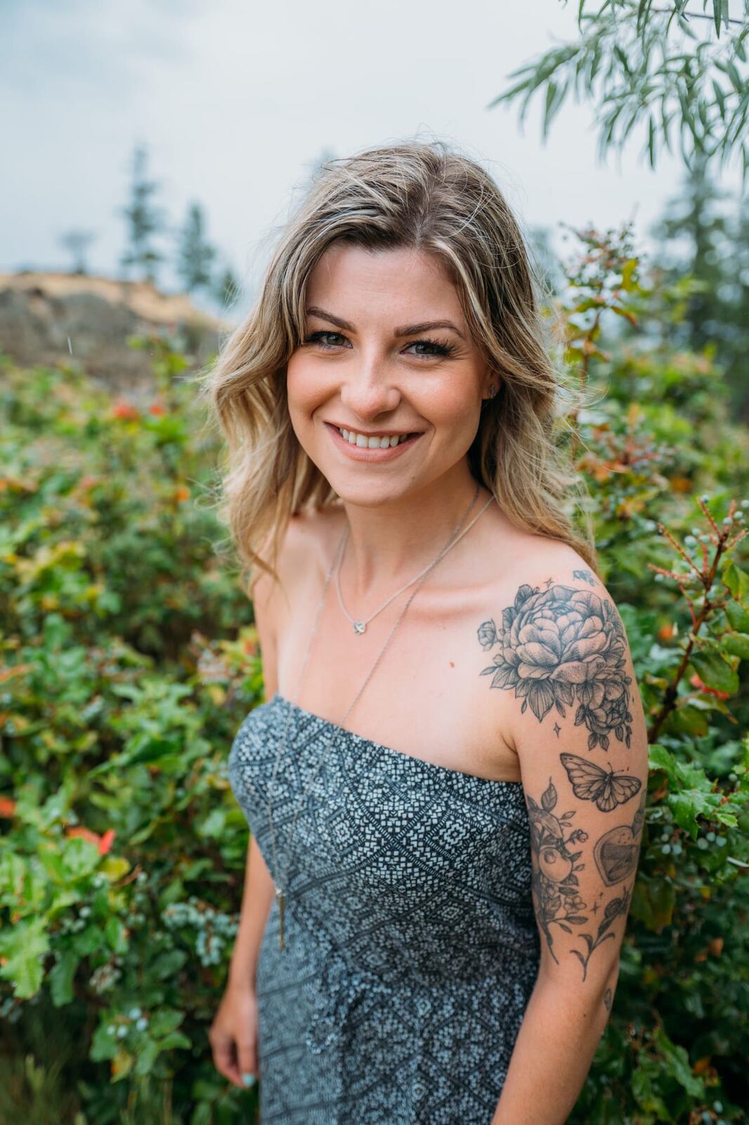Sophia by the Lake portraits story frame 3: A multi-outfit Okanagan location session with water, trees, shoreline, denim and red swimwear woven into a summer portrait story.