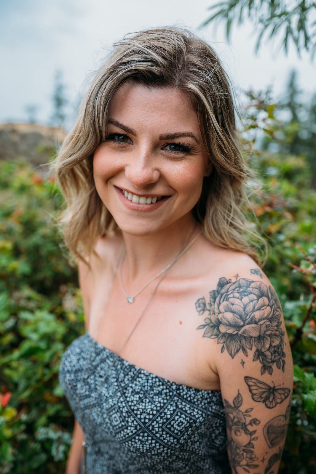 Sophia by the Lake portraits story frame 4: A multi-outfit Okanagan location session with water, trees, shoreline, denim and red swimwear woven into a summer portrait story.