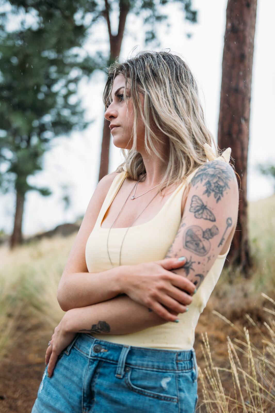 Sophia by the Lake portraits story frame 14: A multi-outfit Okanagan location session with water, trees, shoreline, denim and red swimwear woven into a summer portrait story.