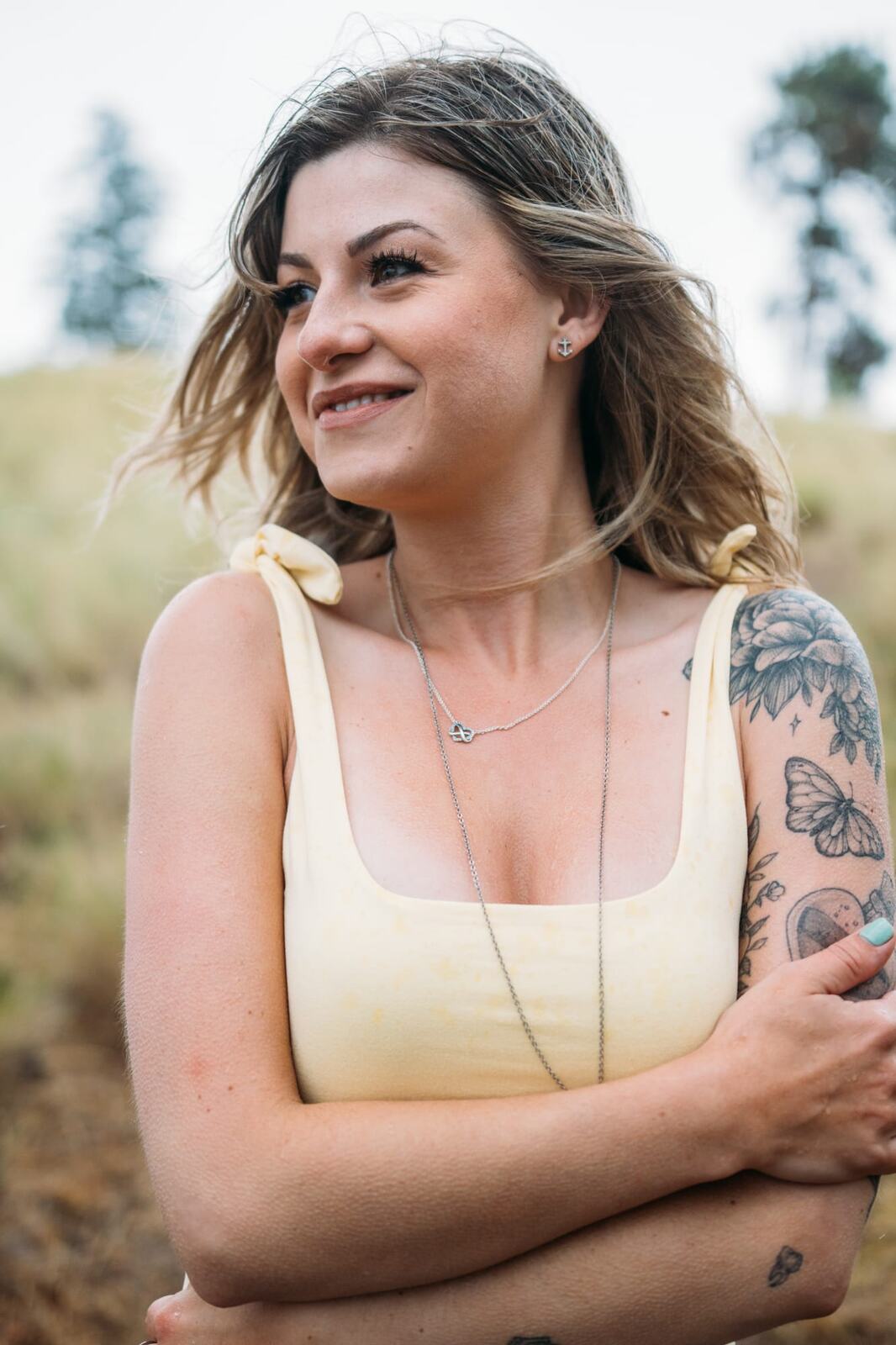 Sophia by the Lake portraits story frame 15: A multi-outfit Okanagan location session with water, trees, shoreline, denim and red swimwear woven into a summer portrait story.