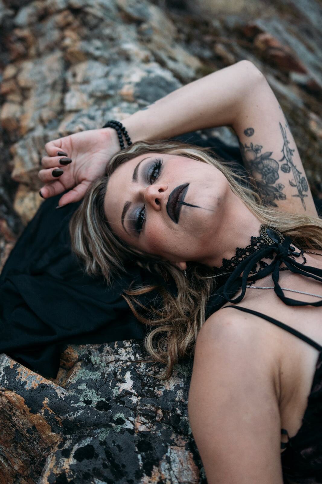 Sophia Halloween portraits story frame 18: A darker seasonal portrait story with candles, rain, rocks, and a little ritual atmosphere.