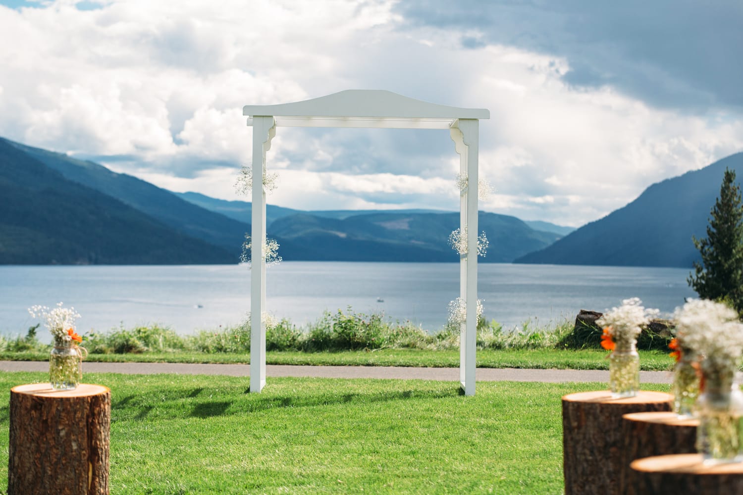 Tia and Matt weddings story frame 18: A Mabel Lake Airpark wedding in the North Okanagan, with grass-runway scenery, mountain openness and a warm end-of-night invitation..