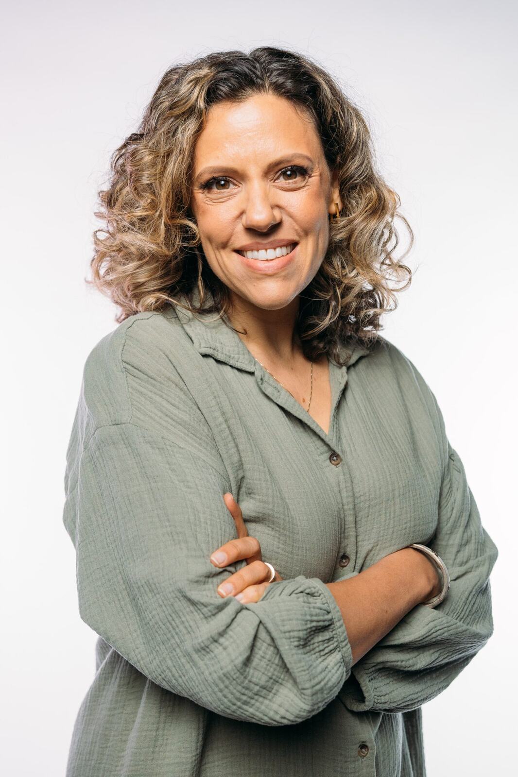 Trisha Miltimore corporate story frame 2: Personal-brand portraits for Trisha Miltimore in Kelowna, moving from clean business profile images into darker wood-wall portraits with black wardrobe and confident brand range..