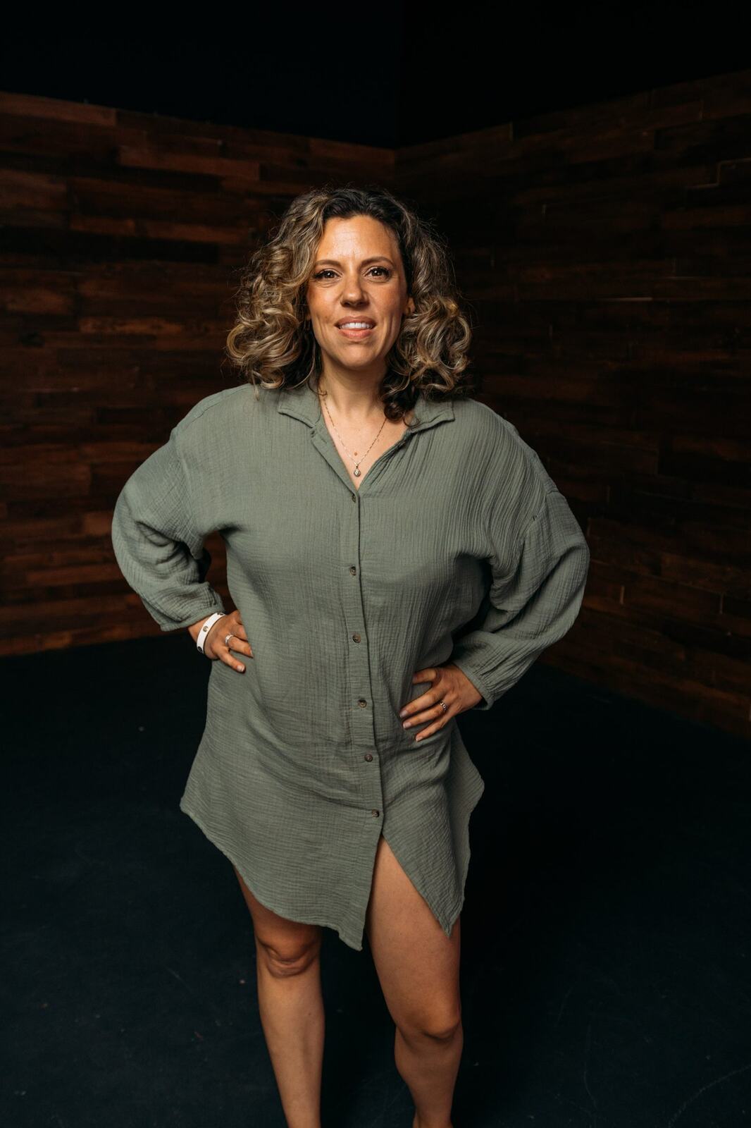 Trisha Miltimore corporate story frame 3: Personal-brand portraits for Trisha Miltimore in Kelowna, moving from clean business profile images into darker wood-wall portraits with black wardrobe and confident brand range..