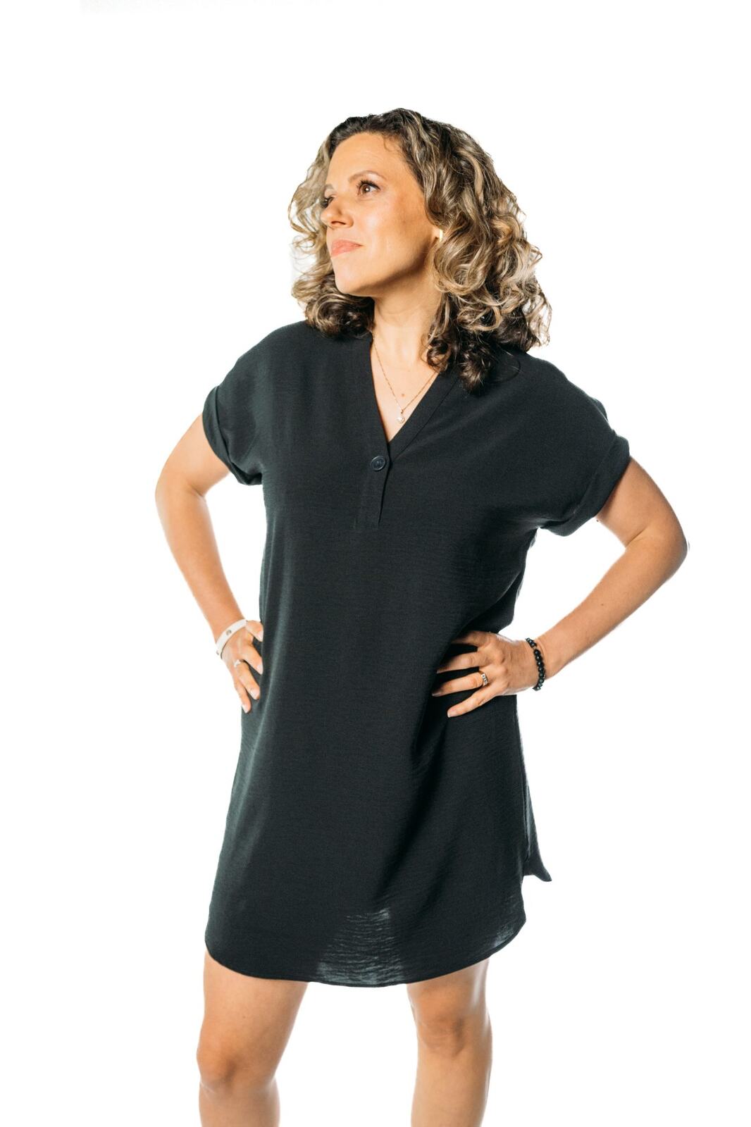 Trisha Miltimore corporate story frame 15: Personal-brand portraits for Trisha Miltimore in Kelowna, moving from clean business profile images into darker wood-wall portraits with black wardrobe and confident brand range..